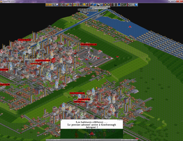 Schermata di OpenTTD con città, strade e linee ferroviarie